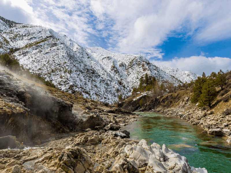 A river running through mountains dusted with snow near Boise, ID