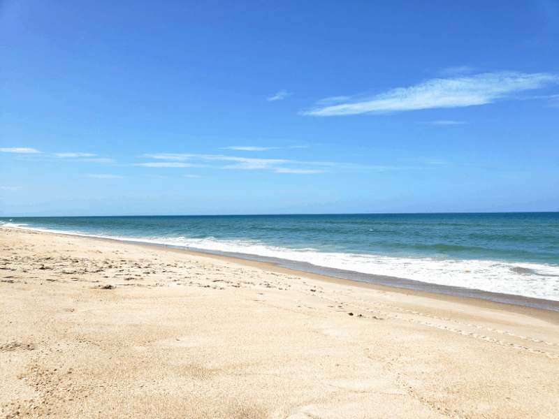 An empty sand beach on the ocean