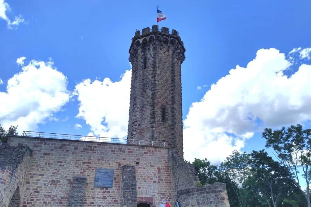 A stone tower with the French flag at the top