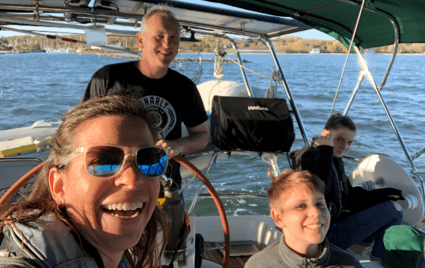 A selfie of the sailing family on their boat as they depart their home marina