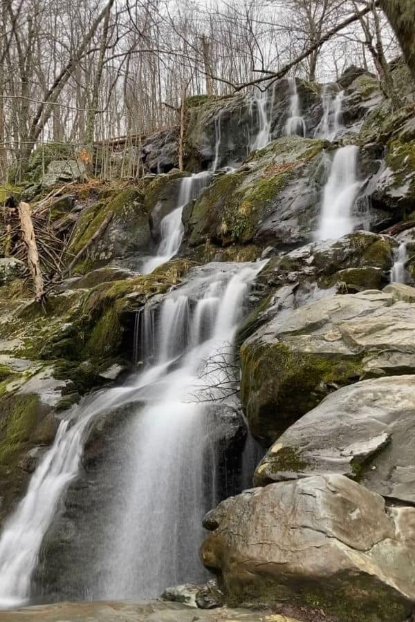 A waterfall flowing over moss-covered rocks