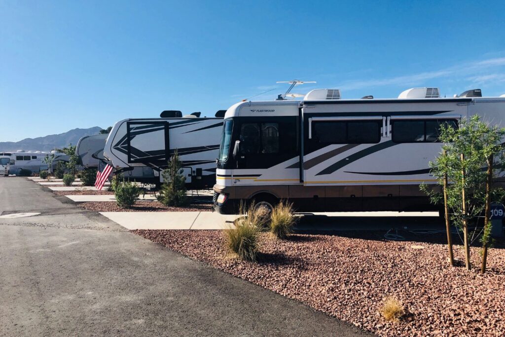 Rows of RVs parked in a desert-like setting
