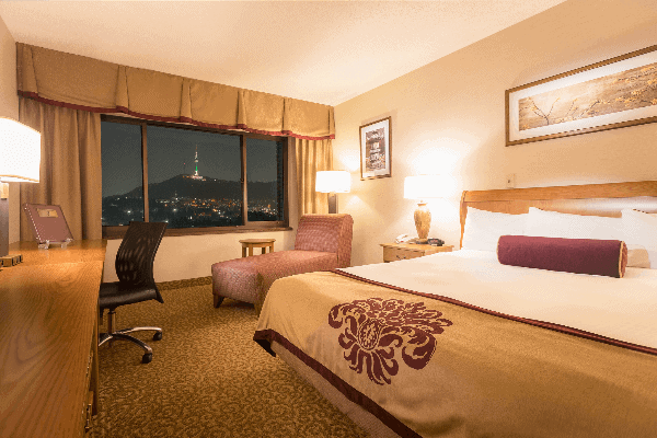 The luxurious rooms at Dragon Hill Lodge with a view of Seoul Tower from the window.