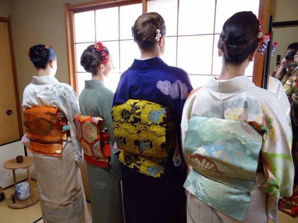 View from behind of four women dressed in kimonos
