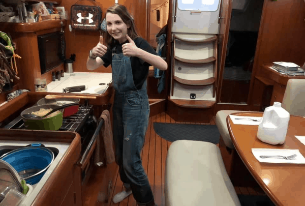 A young girl cooking in the galley of the the 2006 Beneteau 393