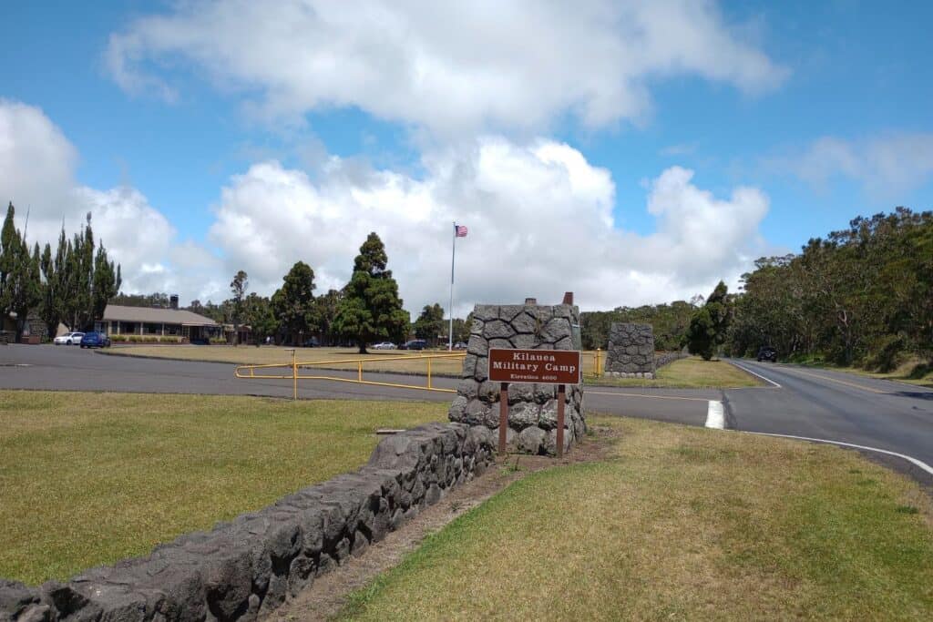 The Kilauea Military Camp sign in front of a stone entryway