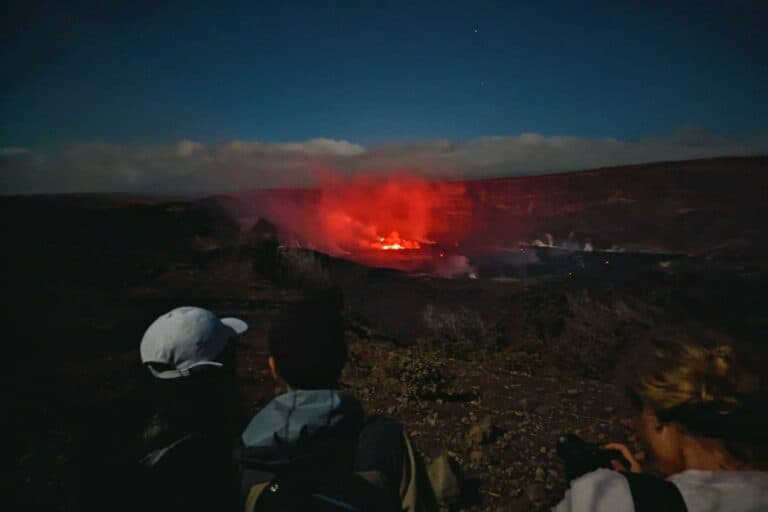 People gathered at a lookout point to watch Kilauea Volcano erupting at night