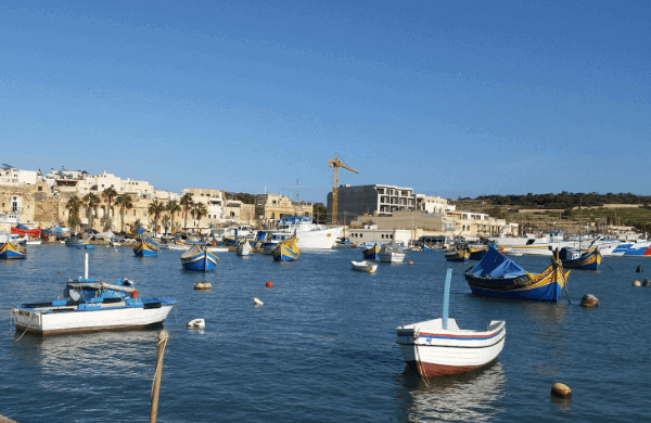 Colorful boats floating in a harbor in Malta