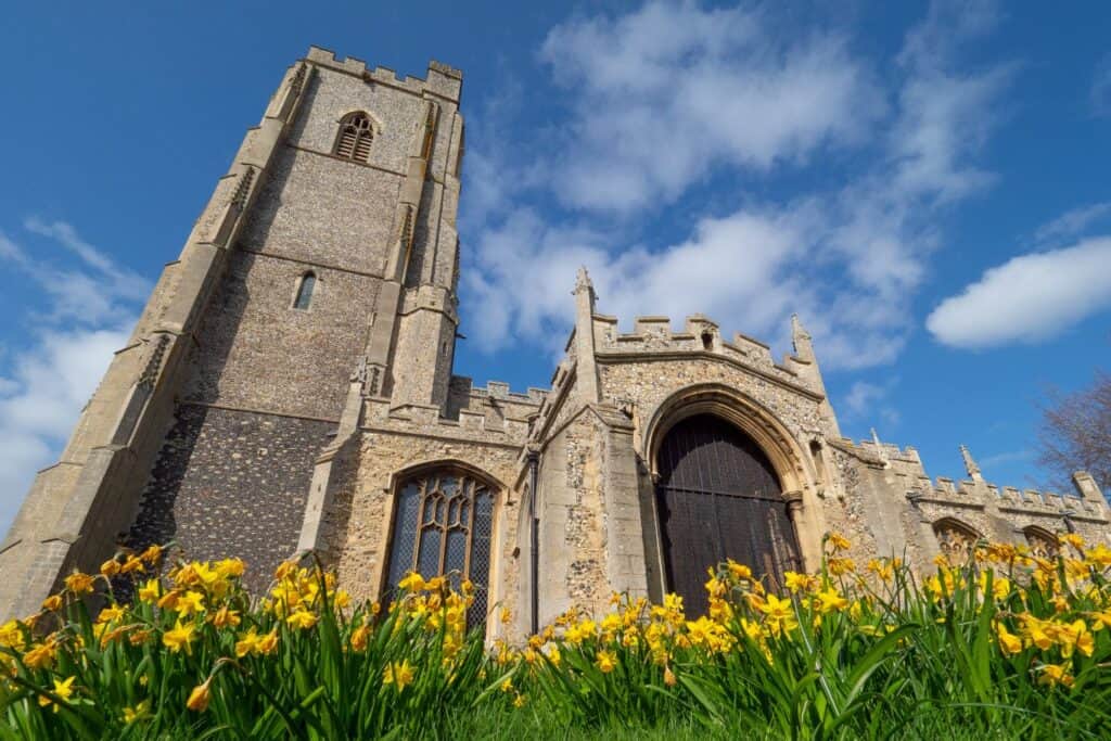 A church with yellow flowers in front