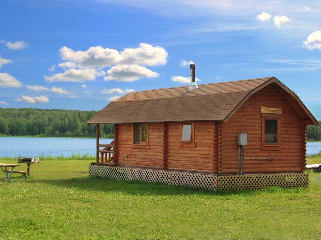 A wood cabin next to Otter Lake in Alaska