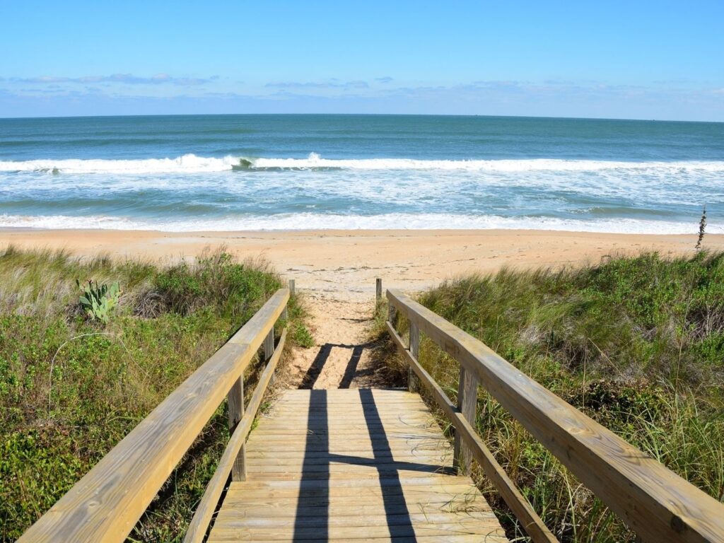 A wooden boardwalk leading to a beach