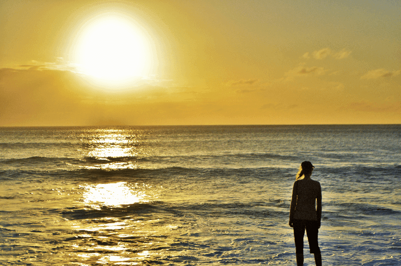 Silhouette of a person watching the sunset in Hawaii