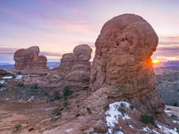 Tall red rock formations with a dusting of snow - book a winter rental in Moab