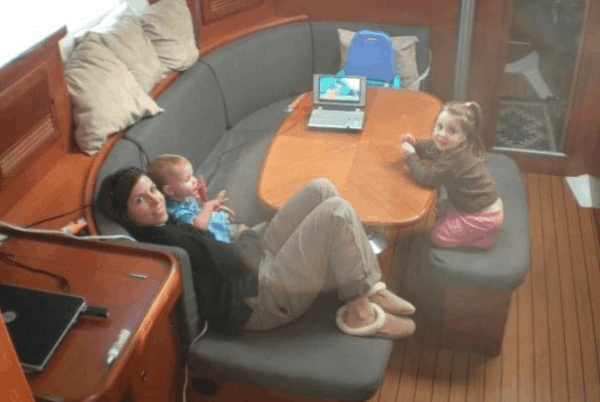 The author and two young children in the salon of their 39 ft boat