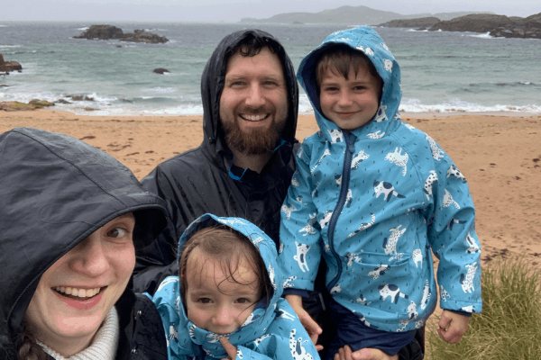 The family wearing rain coats on the beach in Ireland 