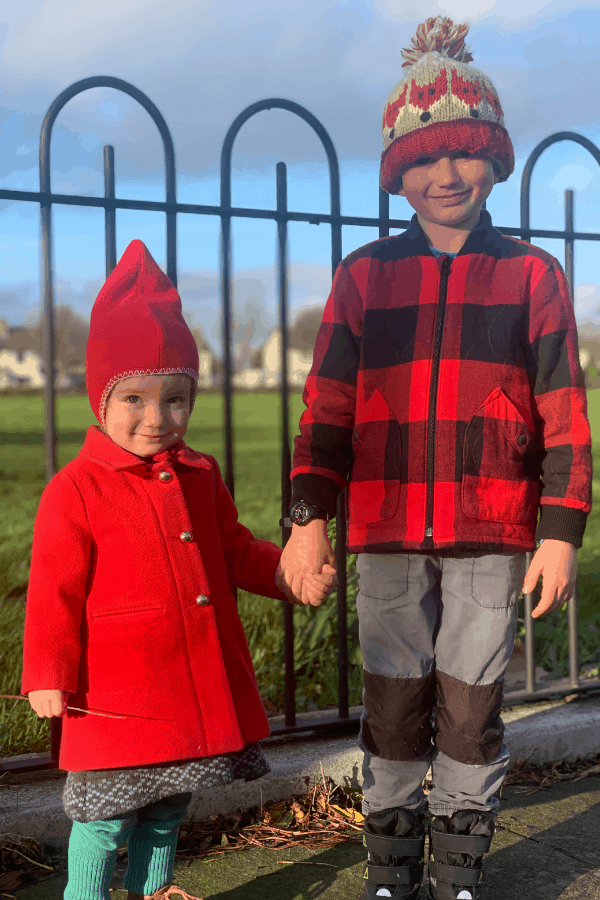 The Kift children in red coats, holding hands