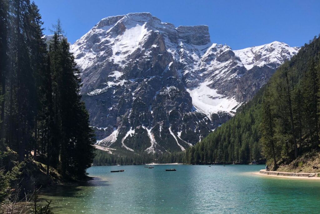 A turquoise lake in front of snow-capped mountains