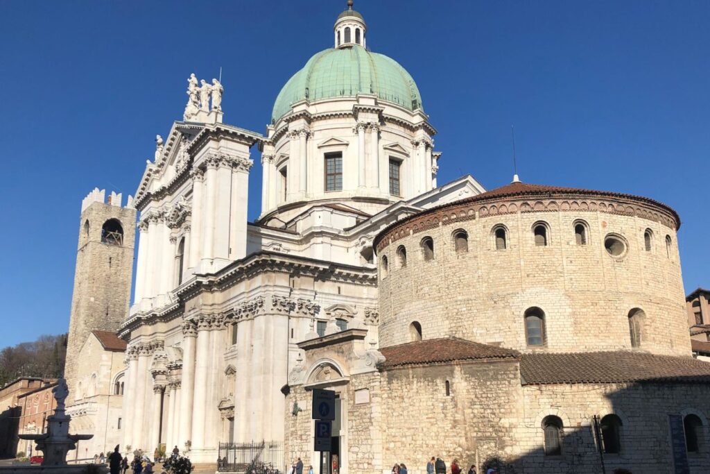 A  white building with a green copper dome