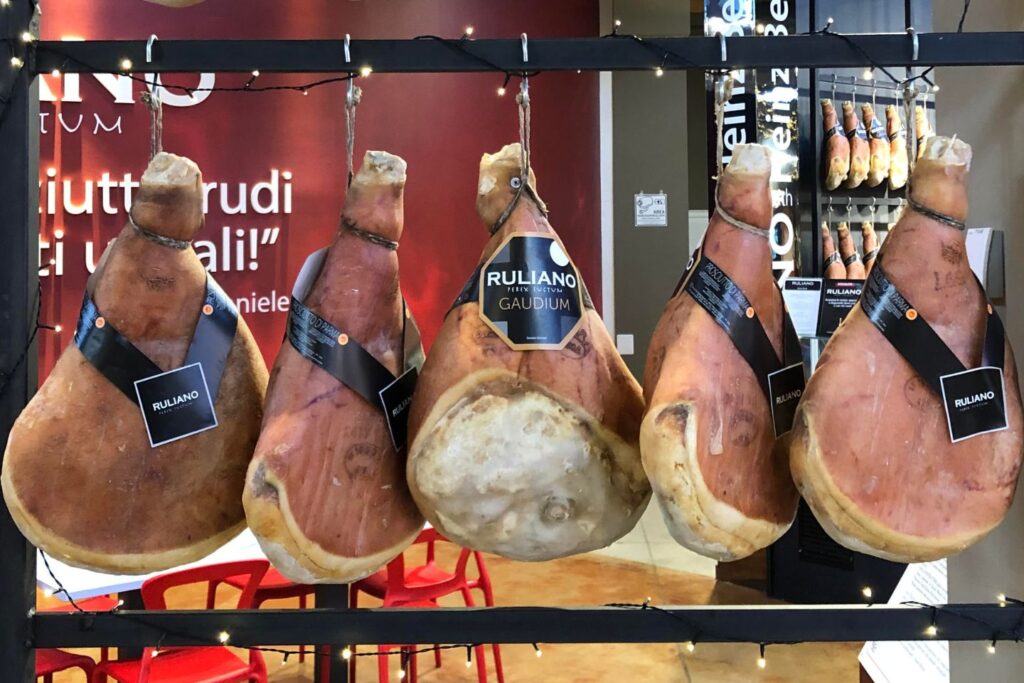 Legs of Parma ham hanging in a store