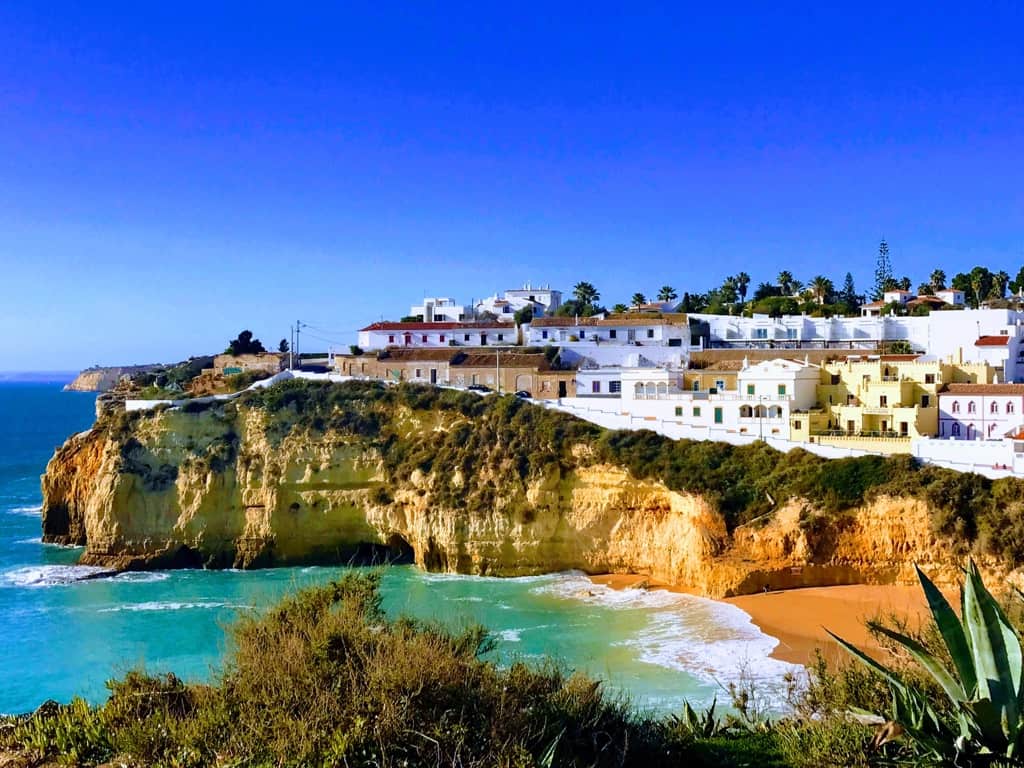 Homes on the cliffs of Carvoeiro overlooking the beach in the Algarve region of Portugal