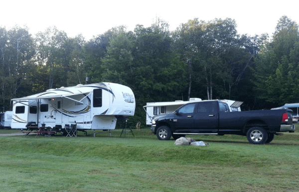 Picture of a 5th wheel RV trailer and large black pick-up truck