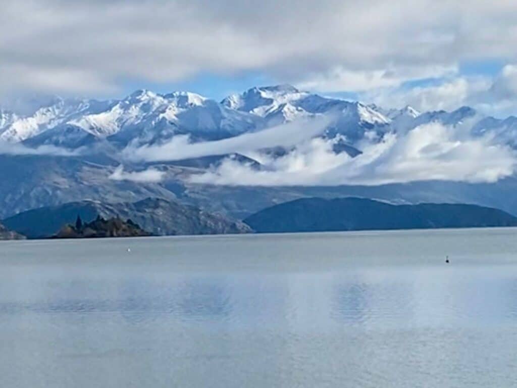 Snow-capped mountains next to a lake