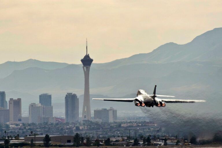 An airplane taking off with the Las Vegas skyline in the background
