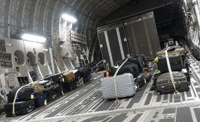 Space-A passenger luggage strapped to the floor of a C-17