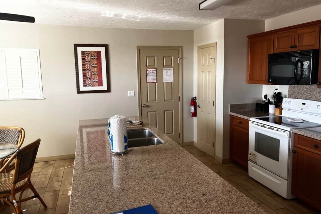 A kitchen with long counter and dining area