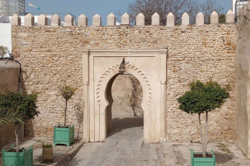 An arched gateway through a castle wall