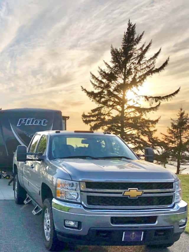A truck parked in front of an RV