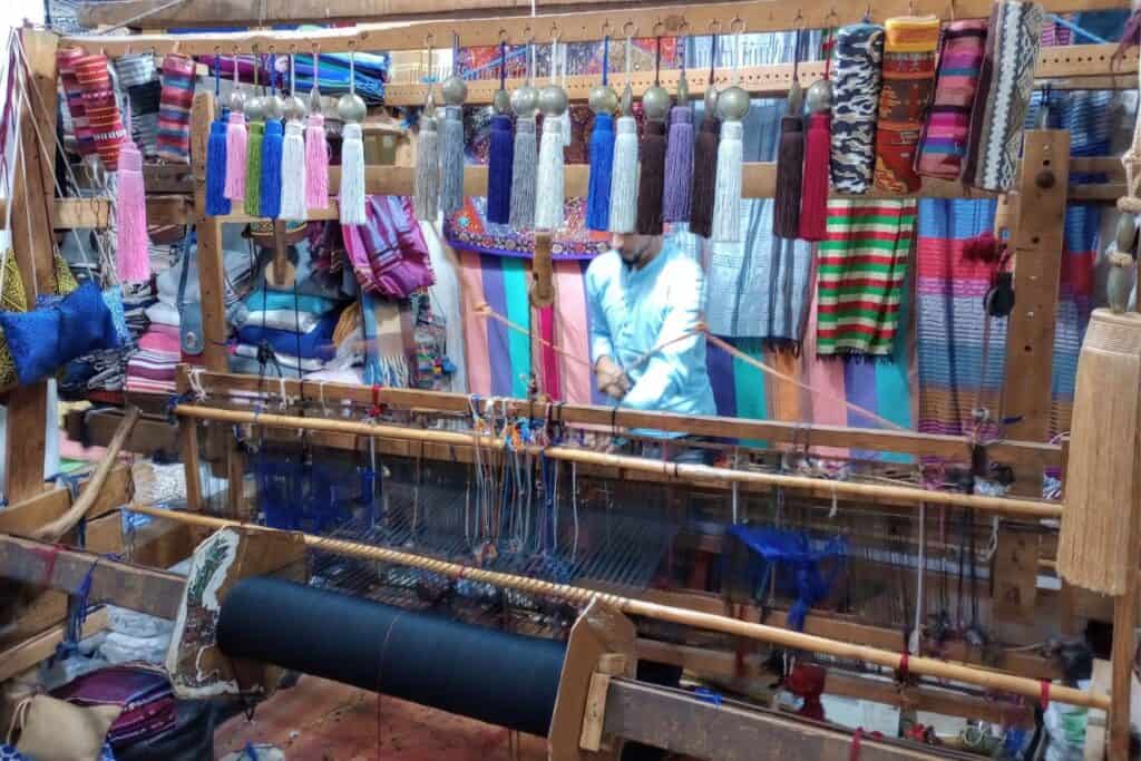 A man working on a loom at a shop in the souk of Tangier