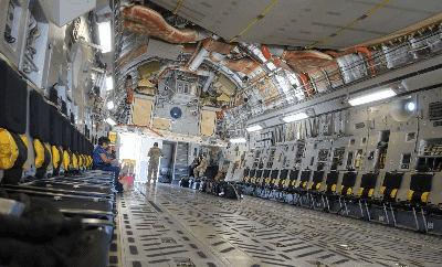 Seats along the side walls of a C-17 with Space-A passengers aboard
