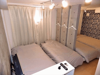 Four beds crammed into a room in an Airbnb in Japan